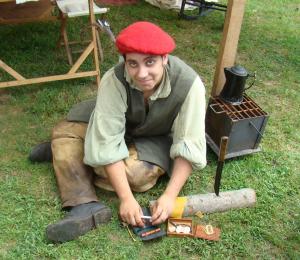 Young settler makes a stem for his pipe.