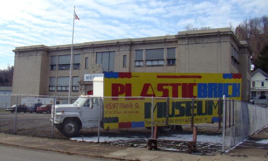 Plastic Brick Museum Sign in front of building.