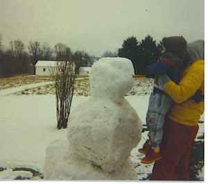 Carrot nose placed on his first snowman.