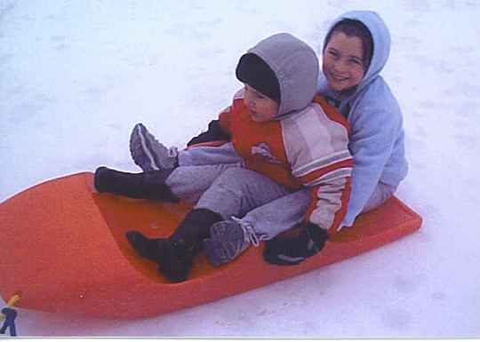Children enjoy a sled ride.