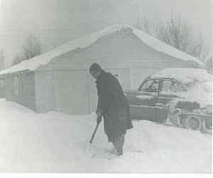 Dad shovels snow.