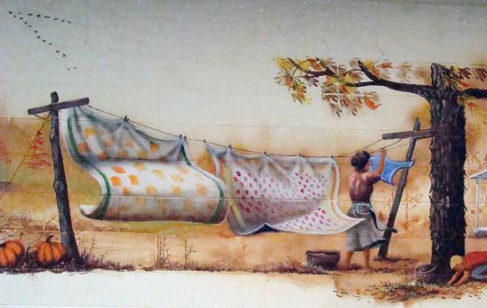 Mom hangs up clothes to dry. (Mural by C.M. Scott)