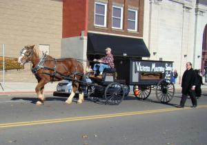 Funeral Hearse followed by mourners