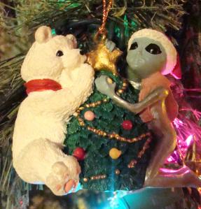 Alien from Roswell, NM helps bear trim the tree.
