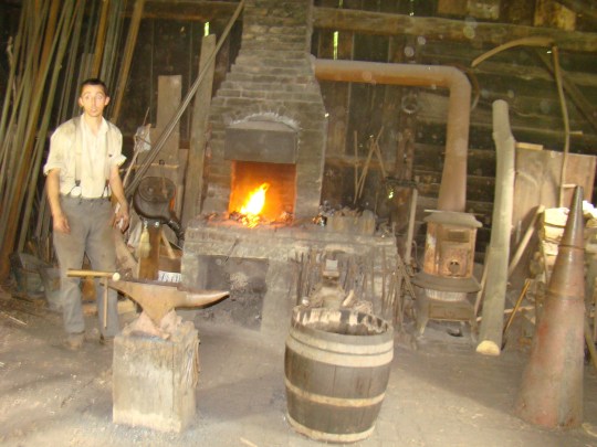 Blacksmith at work in his shop