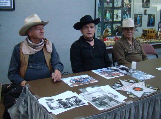 Look-a-likes John Wayne, enjoy visiting with the crowd.