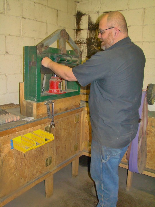 Matt McQuain stamps each knife with BHK logo.