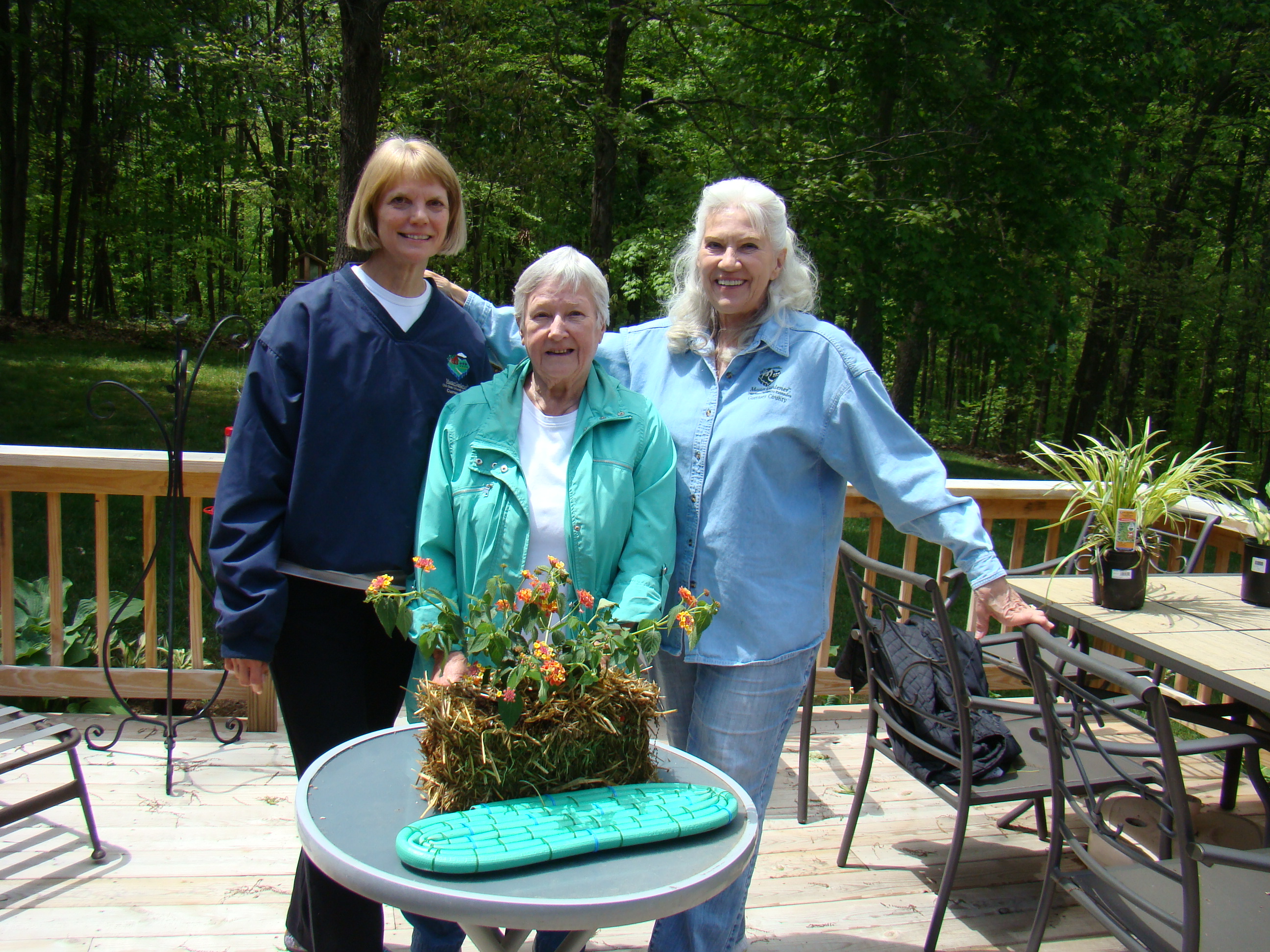 Pat and Garden Club friends sharing their straw bale garden.